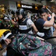 Police beat a protester Dec. 1 in Admiralty.